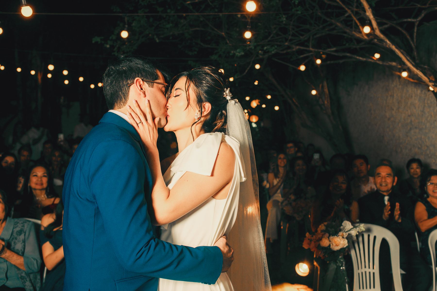 Couple under string lights in the evening