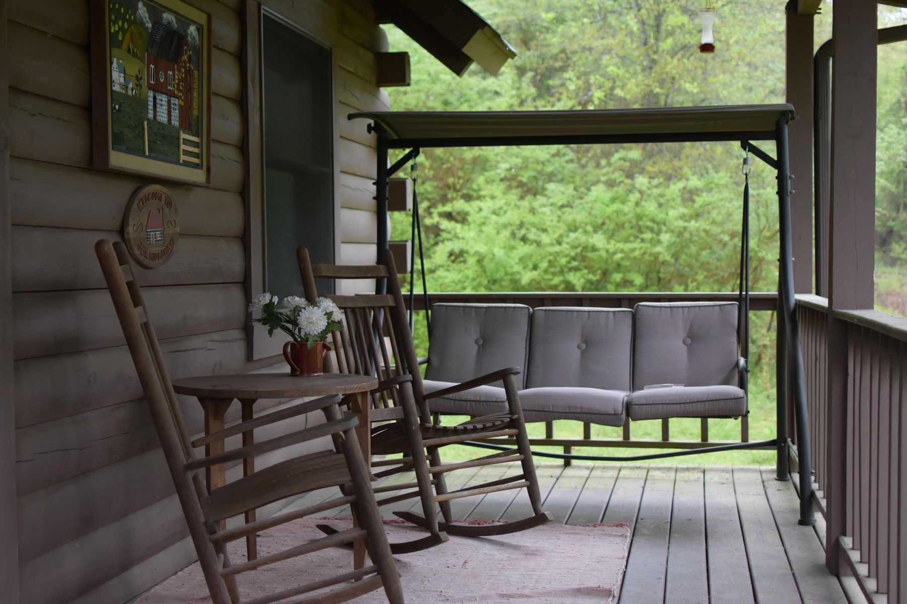 Porch with rocking chairs looking into the trees